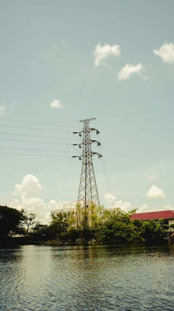 a-power-line-tower-by-water-gnkudz0vht4